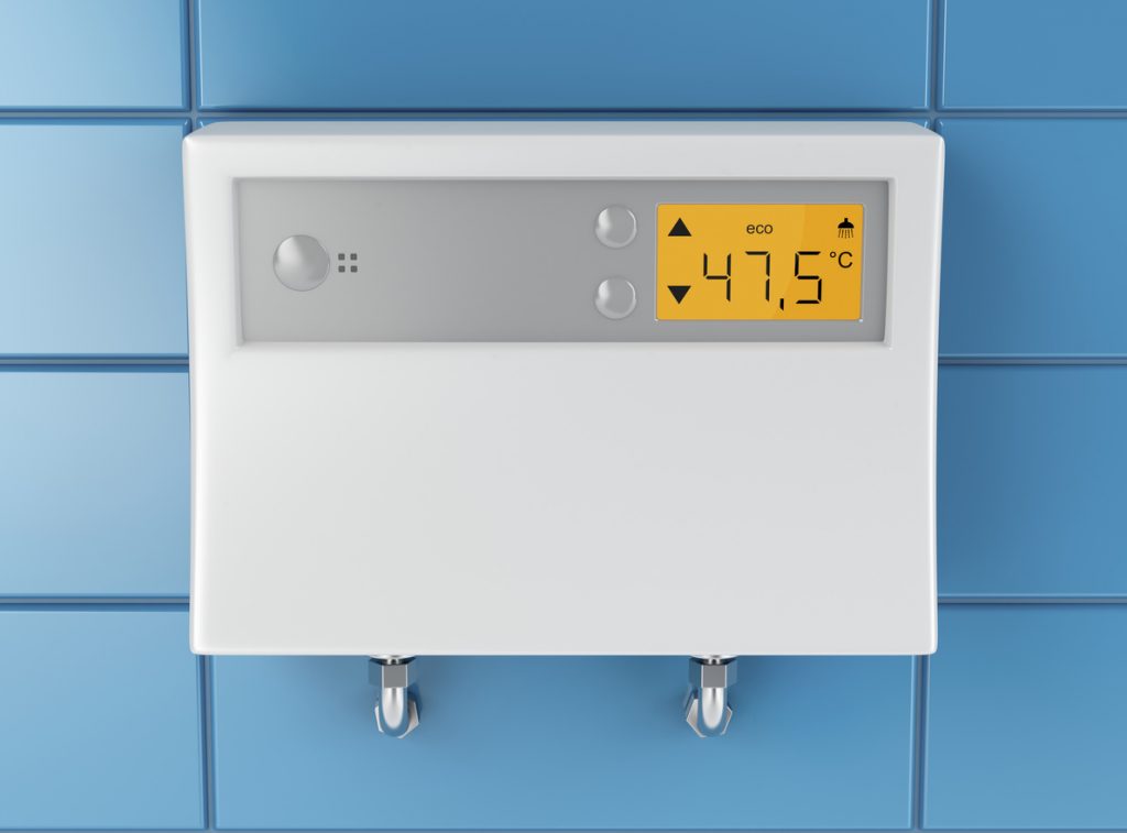 Automatic water heater attached on blue tiled wall